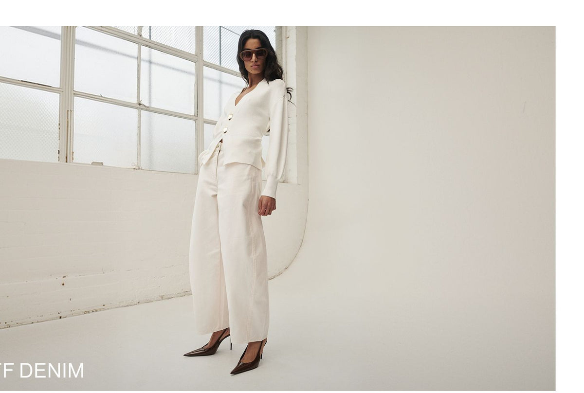 Model posing in a white knit cardigan and white denim with text overlay: "25% OFF DENIM"